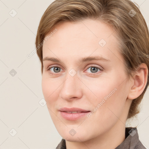 Joyful white young-adult female with medium  brown hair and blue eyes