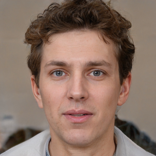 Joyful white adult male with short  brown hair and grey eyes