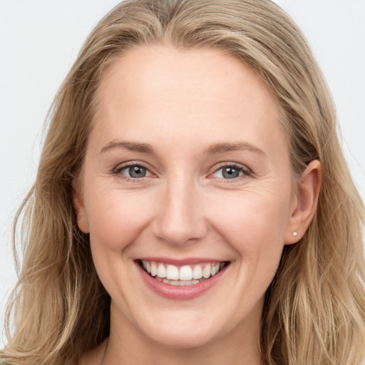 Joyful white young-adult female with long  brown hair and blue eyes