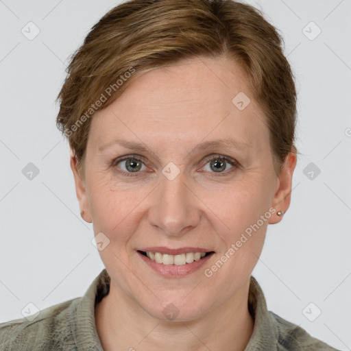 Joyful white adult female with short  brown hair and grey eyes