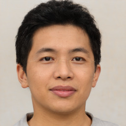 Joyful asian young-adult male with short  brown hair and brown eyes