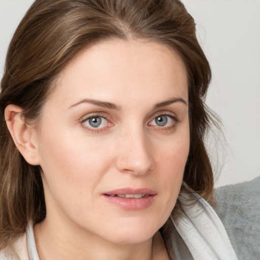 Joyful white young-adult female with medium  brown hair and blue eyes