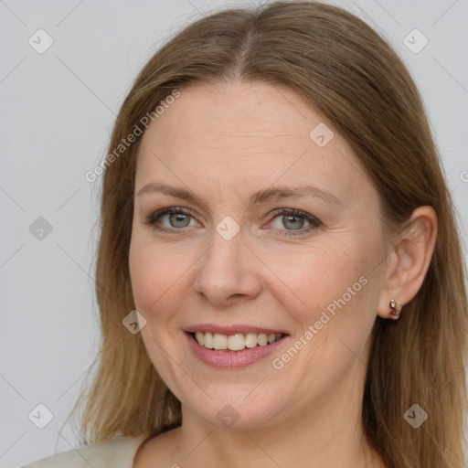 Joyful white adult female with long  brown hair and grey eyes