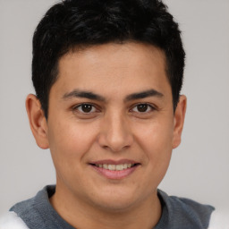 Joyful latino young-adult male with short  brown hair and brown eyes