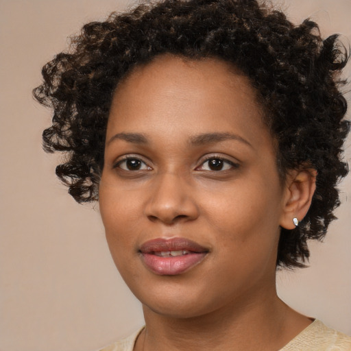Joyful black young-adult female with medium  black hair and brown eyes