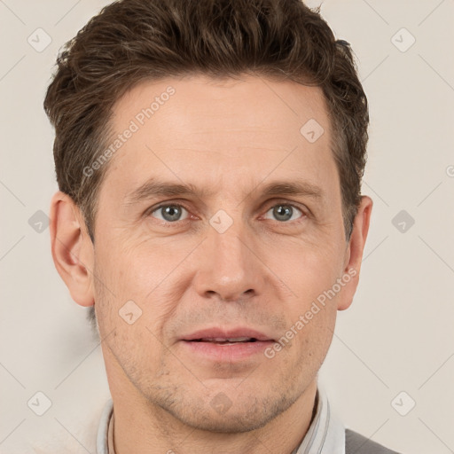 Joyful white adult male with short  brown hair and grey eyes