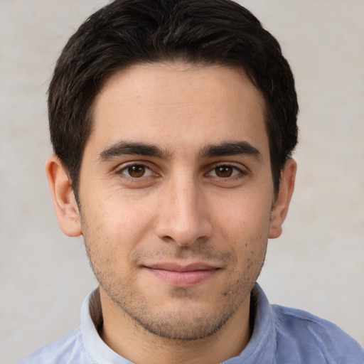 Joyful white young-adult male with short  brown hair and brown eyes