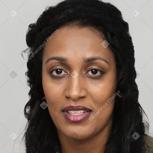 Joyful black young-adult female with long  black hair and brown eyes