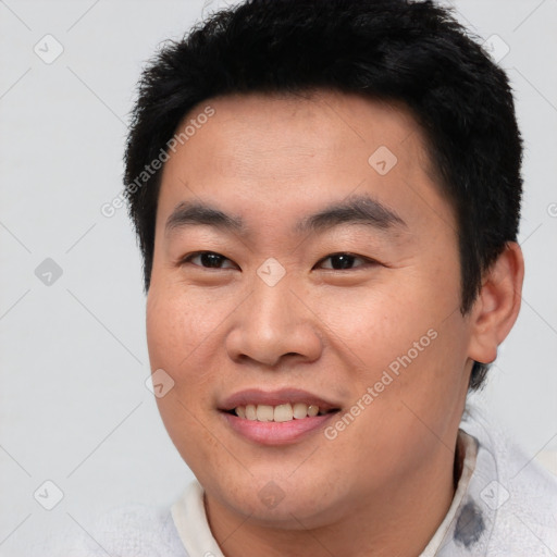 Joyful asian young-adult male with short  black hair and brown eyes