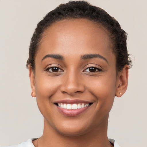 Joyful latino young-adult female with short  brown hair and brown eyes