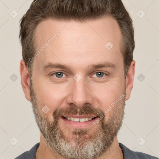 Joyful white adult male with short  brown hair and grey eyes