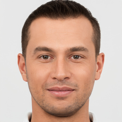 Joyful white young-adult male with short  brown hair and brown eyes