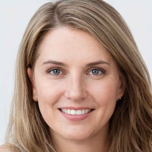 Joyful white young-adult female with long  brown hair and grey eyes