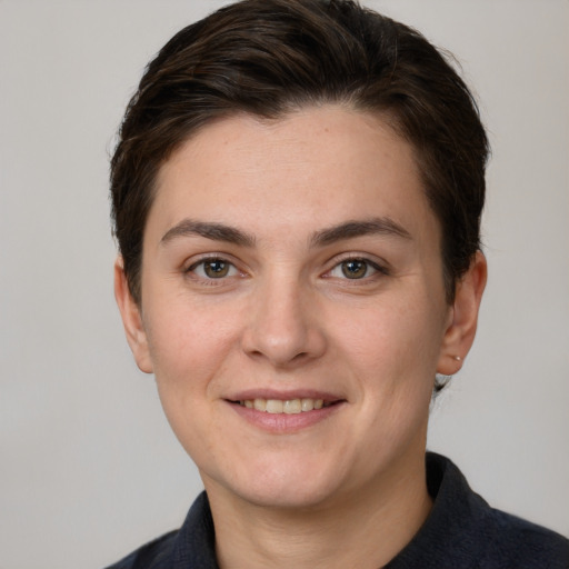 Joyful white young-adult female with short  brown hair and grey eyes