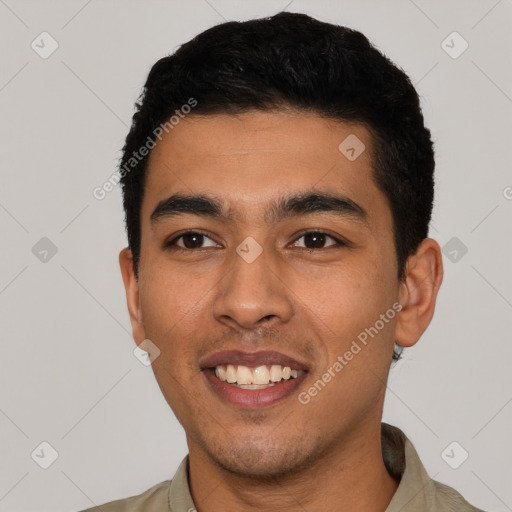 Joyful latino young-adult male with short  black hair and brown eyes