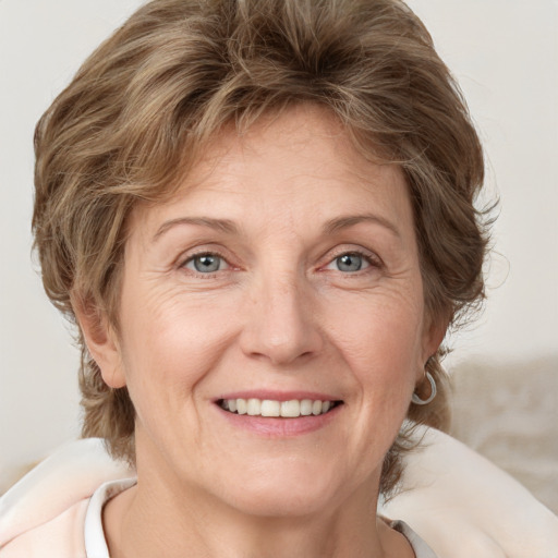 Joyful white adult female with medium  brown hair and blue eyes