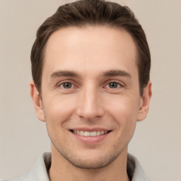 Joyful white young-adult male with short  brown hair and brown eyes