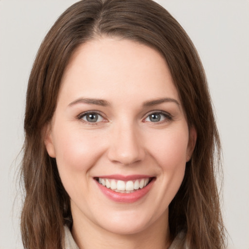 Joyful white young-adult female with medium  brown hair and grey eyes