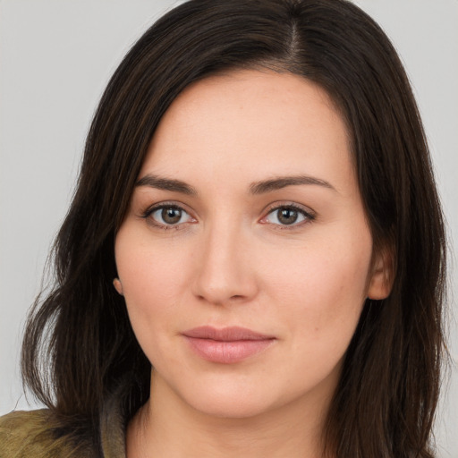 Joyful white young-adult female with long  brown hair and brown eyes