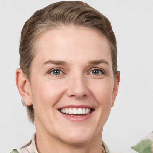 Joyful white young-adult female with short  brown hair and grey eyes