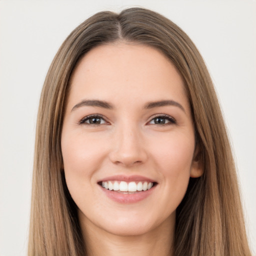 Joyful white young-adult female with long  brown hair and brown eyes