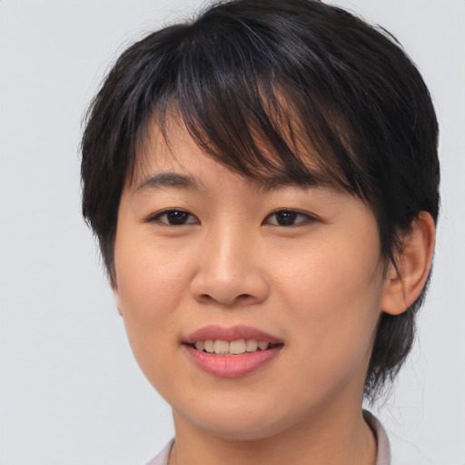 Joyful asian young-adult female with medium  brown hair and brown eyes