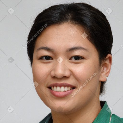 Joyful asian young-adult female with short  brown hair and brown eyes