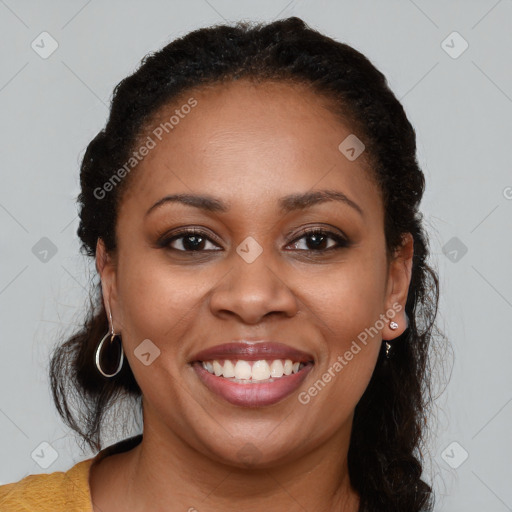 Joyful black young-adult female with long  brown hair and brown eyes