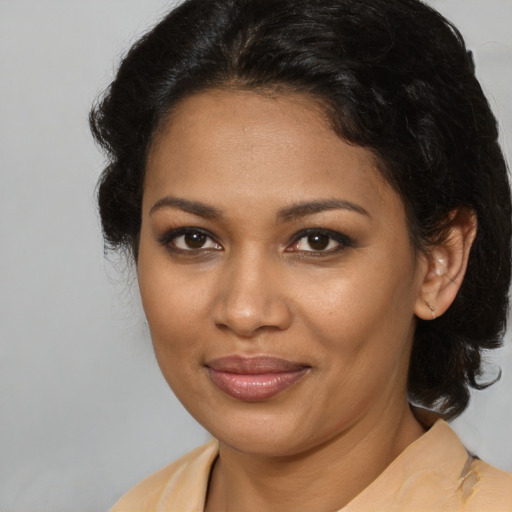 Joyful black young-adult female with medium  brown hair and brown eyes