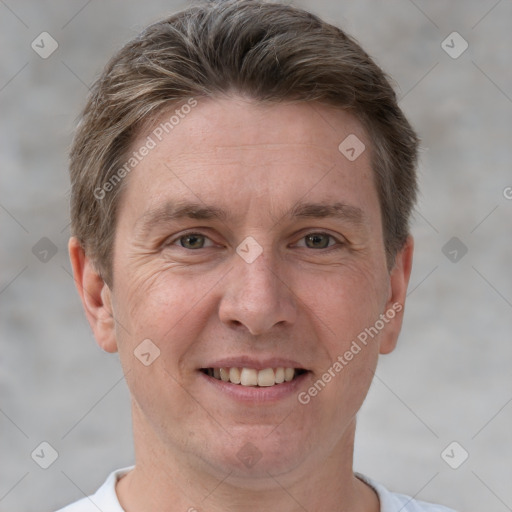 Joyful white adult male with short  brown hair and grey eyes