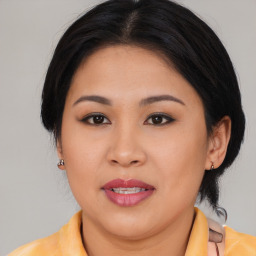 Joyful asian young-adult female with medium  brown hair and brown eyes