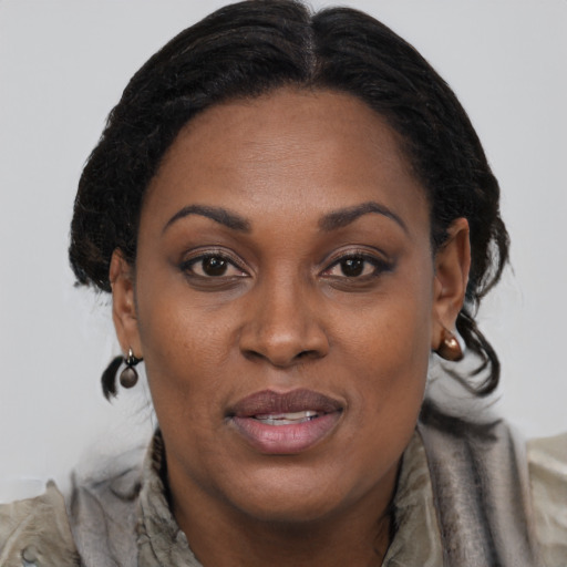 Joyful black adult female with medium  brown hair and brown eyes