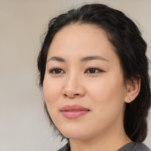 Joyful asian young-adult female with medium  black hair and brown eyes