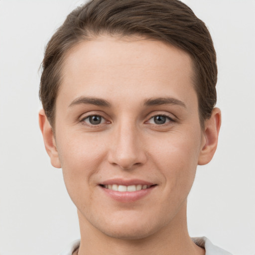 Joyful white young-adult female with short  brown hair and grey eyes