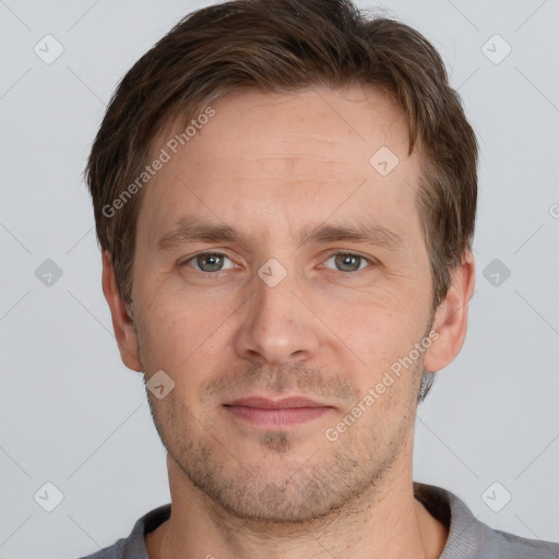 Joyful white adult male with short  brown hair and grey eyes