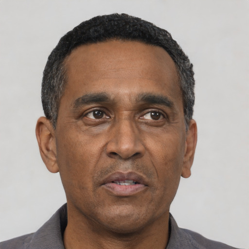 Neutral latino adult male with short  black hair and brown eyes