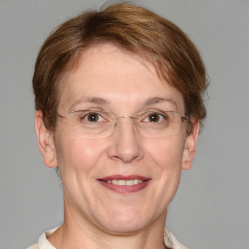 Joyful white adult female with medium  brown hair and blue eyes