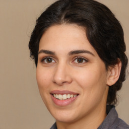 Joyful white adult female with medium  brown hair and brown eyes