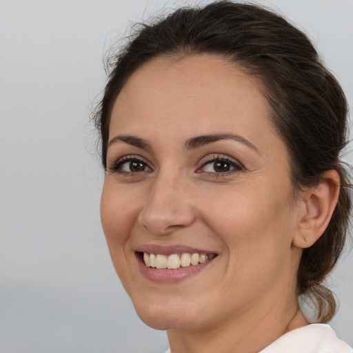 Joyful white young-adult female with medium  brown hair and brown eyes