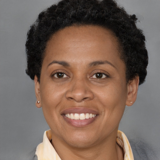 Joyful black young-adult female with short  brown hair and brown eyes
