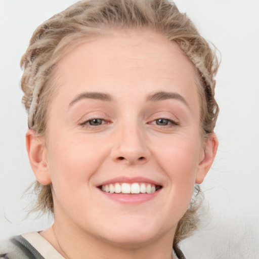 Joyful white young-adult female with medium  brown hair and blue eyes