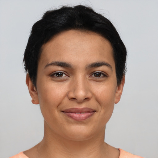 Joyful latino young-adult female with short  brown hair and brown eyes