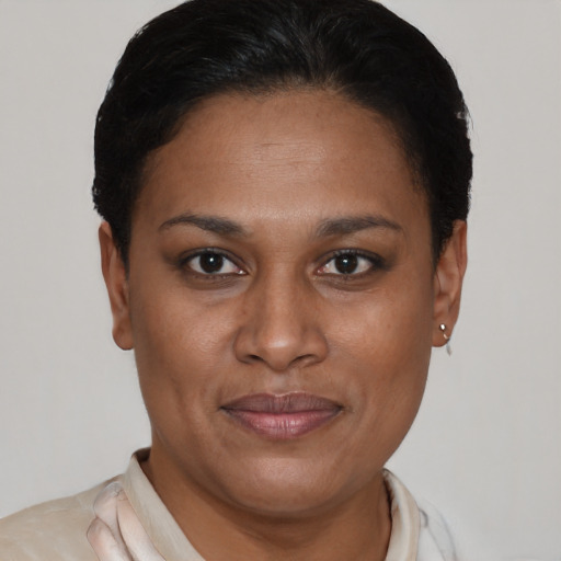 Joyful latino adult female with short  brown hair and brown eyes