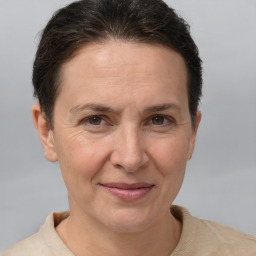 Joyful white adult female with short  brown hair and brown eyes