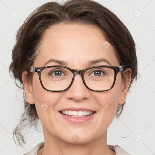 Joyful white adult female with medium  brown hair and grey eyes