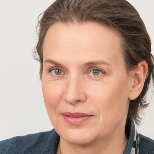 Joyful white adult female with medium  brown hair and grey eyes