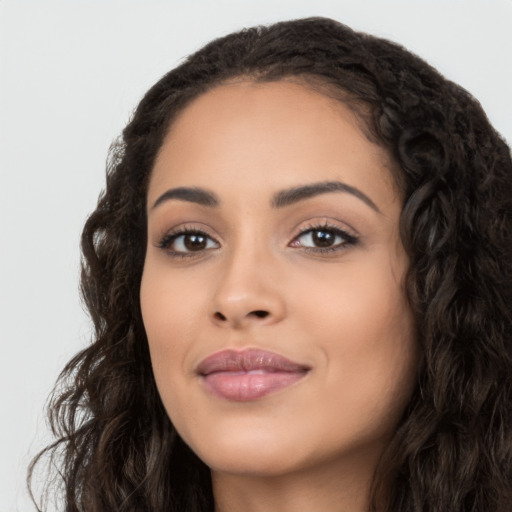 Joyful latino young-adult female with long  black hair and brown eyes