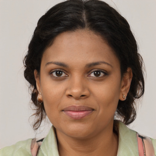 Joyful black young-adult female with medium  brown hair and brown eyes