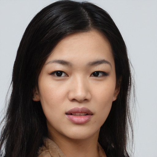 Joyful asian young-adult female with long  black hair and brown eyes