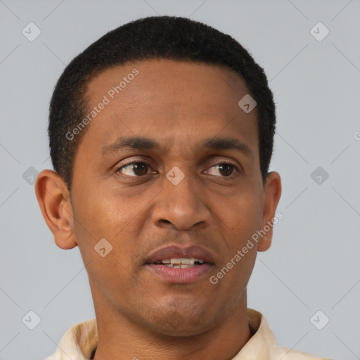 Joyful black young-adult male with short  brown hair and brown eyes